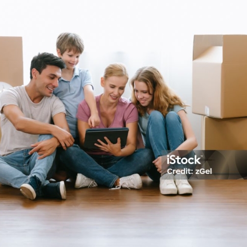 Caucasian Family father mother daughter son sit on the floor using digital tablet shopping online choosing and ordering Furniture, Discussing Decor at home. Lifestyle happy family together relocation
